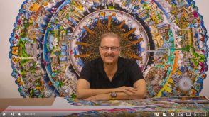 Fazzino sitting in front of his very large circle of life 3d pop artwork