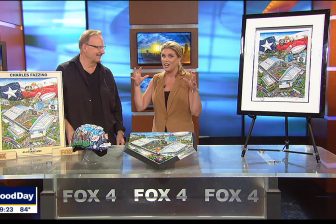 Fazzino talking to Fox 4 anchor about his collection for the MLB All-Star game with a hand-painted helmet and home plate, limited edition print, and poster laid out on the table in front of them