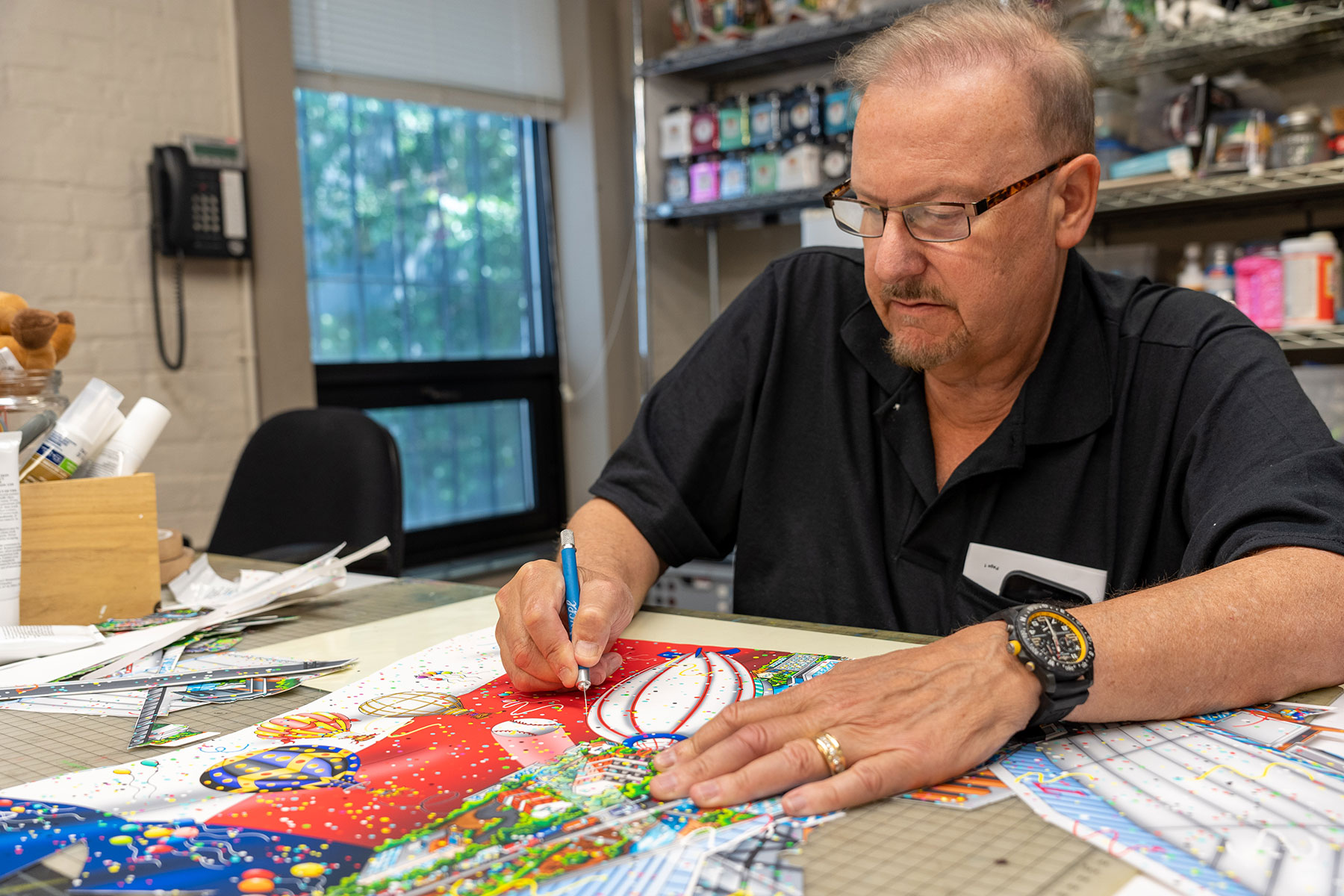 Fazzino in the studio cutting out a blimp for the MLB All-Star game limited edition artwork