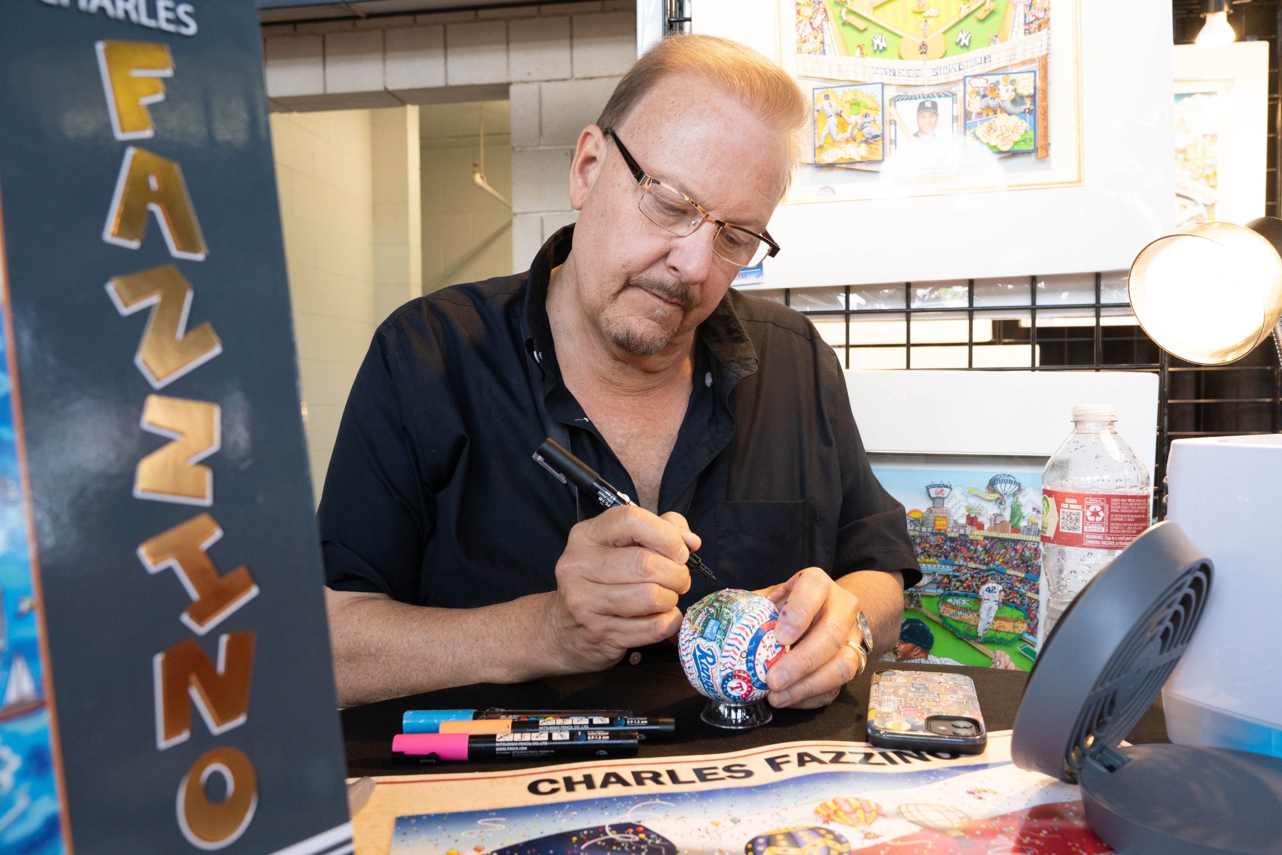 Fazzino signing hand-painted equipment at the MLB All-Star Game booth