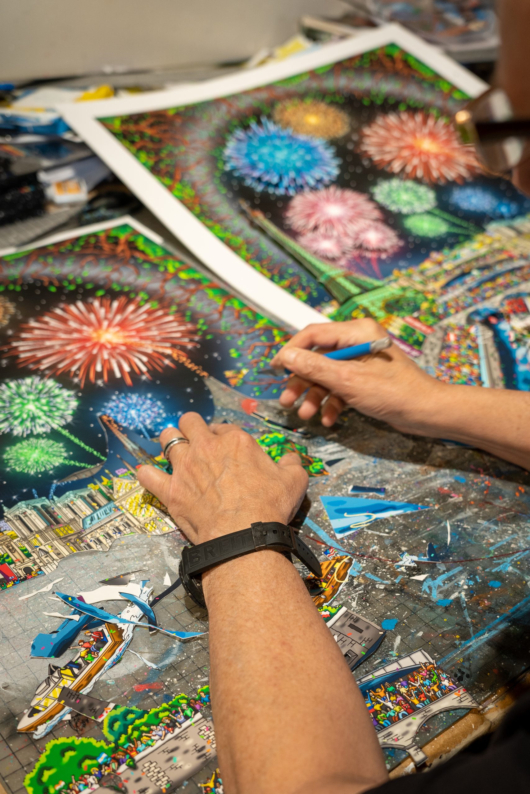 A close up of Fazzino 2024 Paris Olympics artwork showing fireworks and the Paris cityscape being cut out and to create a 3D effect