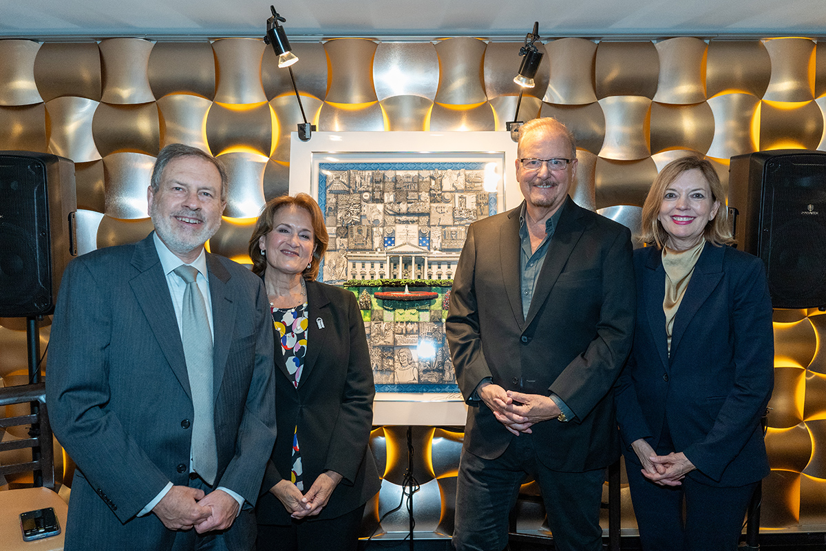 Fazzino, Anita McBride, and Howard Mortman stand smiling at the camera in front of the artwork after it was unveiled 