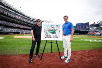 Fazzino and Eli Manning on the field at Yankee Stadium unveiling his artwork to celebrate the NY Giants 100 years